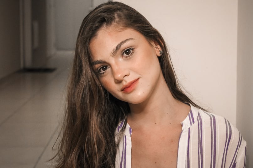 portrait Photo of Woman in White and Blue Stripe Shirt