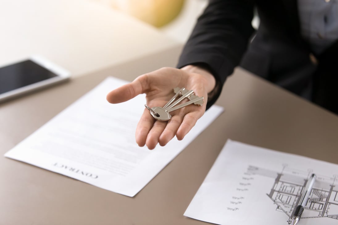 Female hand with keys on it, real estate property deal